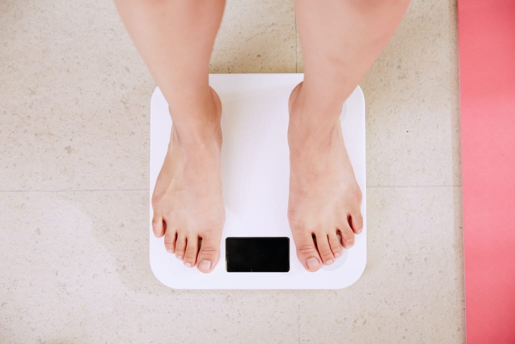 feet on a scale measuring weight loss